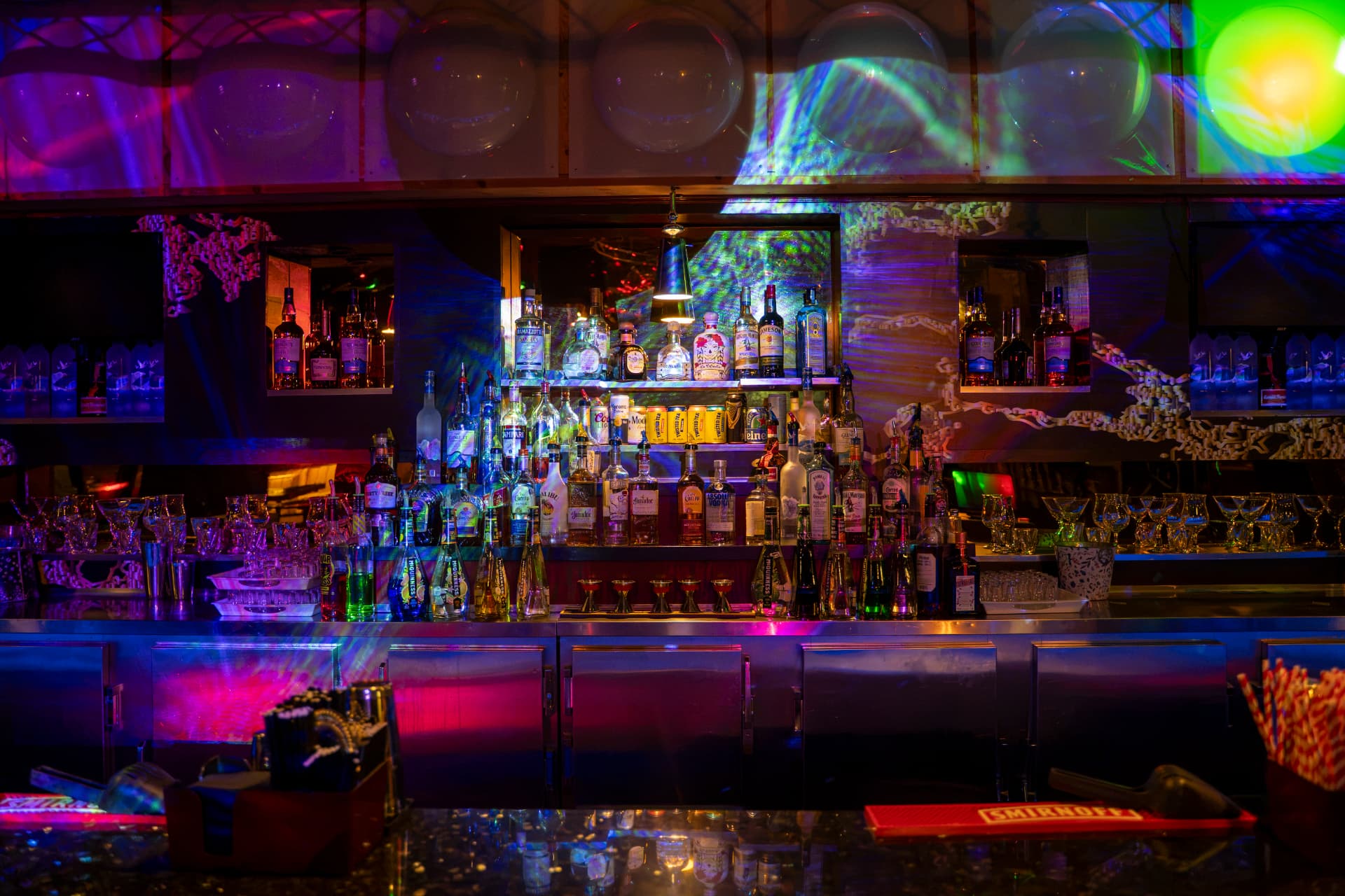 Cactus Jaxx back bar with spirits and colourful projected lighting