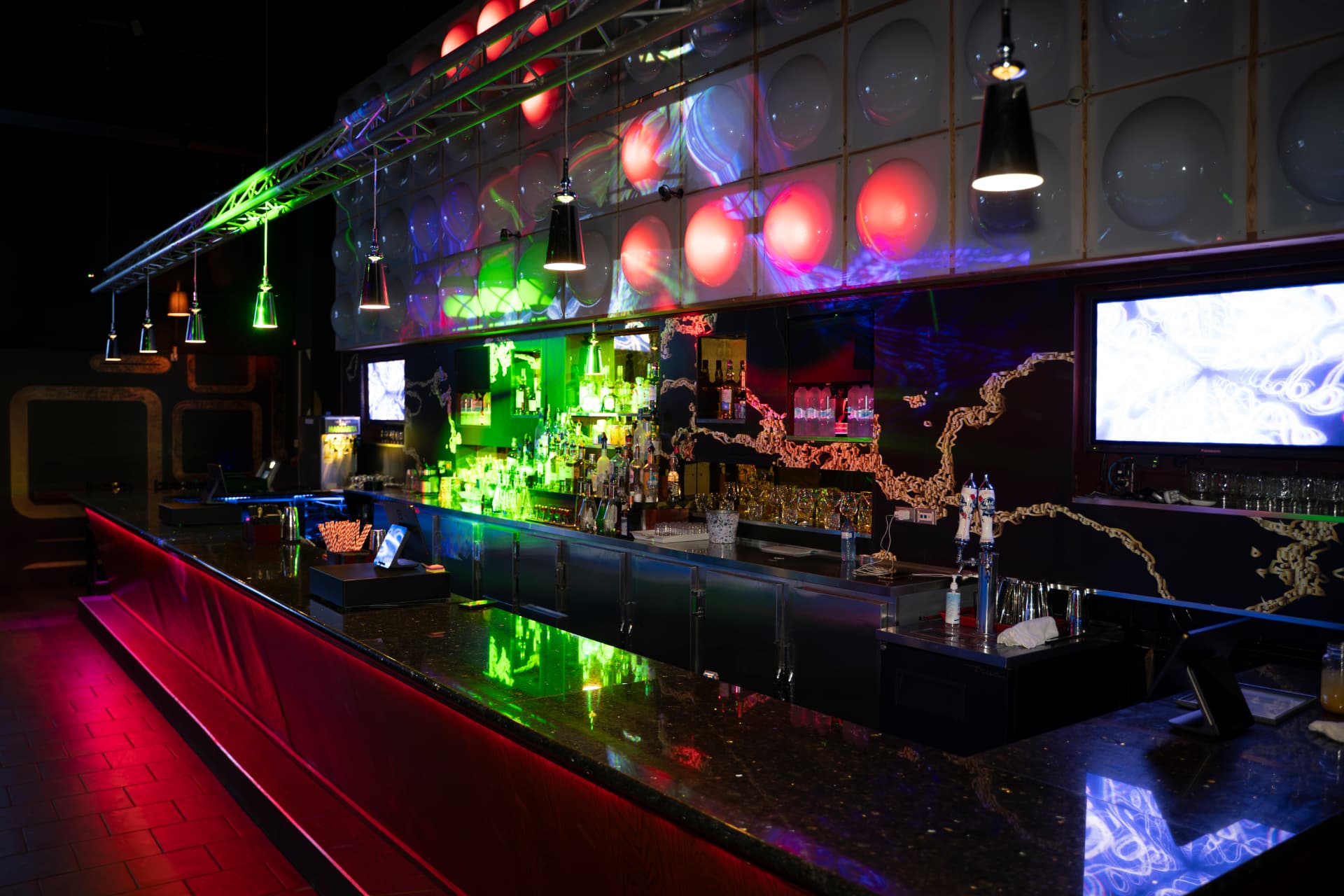 The Cactus Jaxx cocktail bar illuminated in coloured light