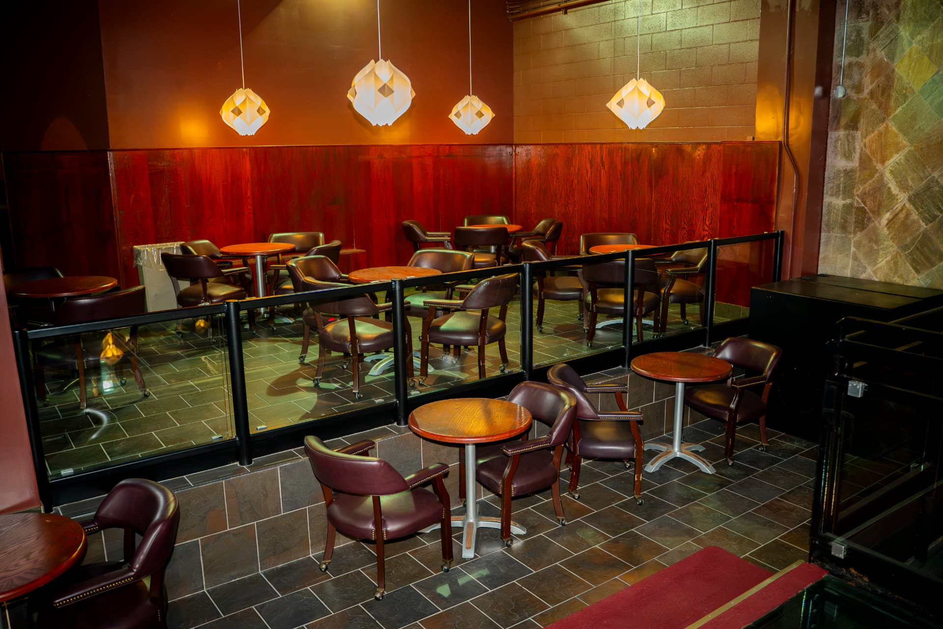 Warm lounge tables and leather chairs arranged across two levels at Cactus Jaxx
